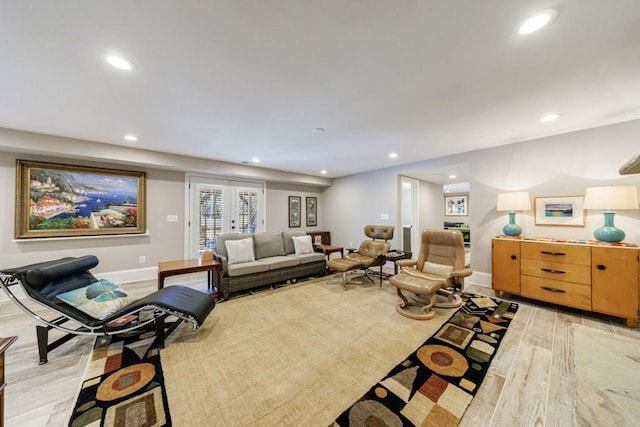 living area with recessed lighting, french doors, light wood-style flooring, and baseboards