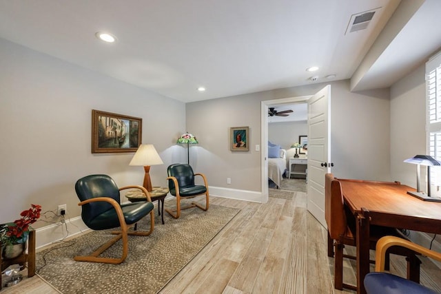 sitting room featuring light wood finished floors, baseboards, visible vents, and recessed lighting