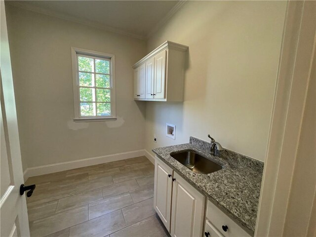 laundry room with sink, washer hookup, ornamental molding, cabinets, and light tile flooring