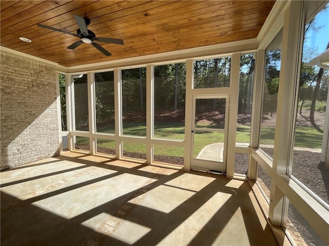 unfurnished sunroom with wooden ceiling and ceiling fan