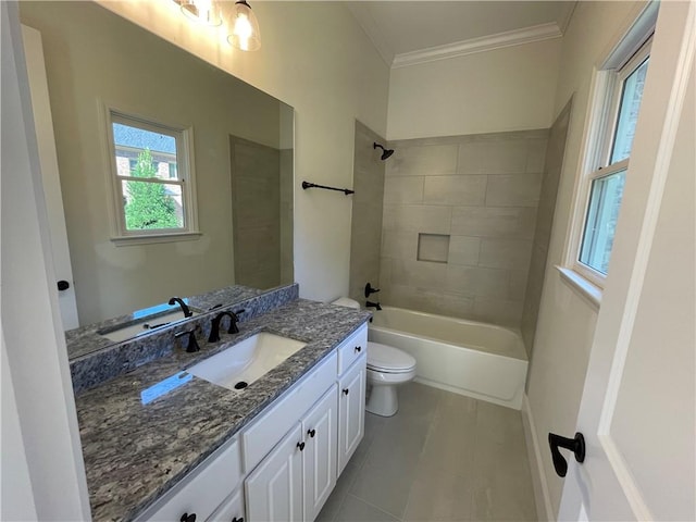 full bathroom with tile floors, toilet, vanity, tiled shower / bath, and crown molding