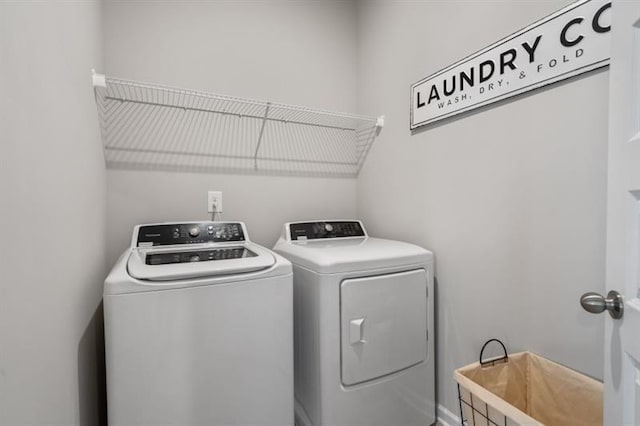 clothes washing area featuring washer and dryer