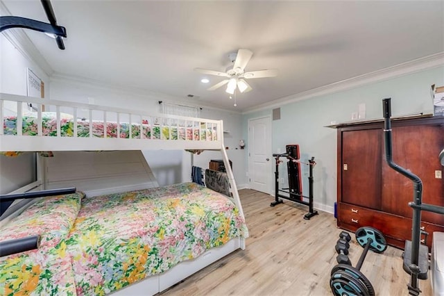 bedroom with crown molding, a ceiling fan, baseboards, and wood finished floors