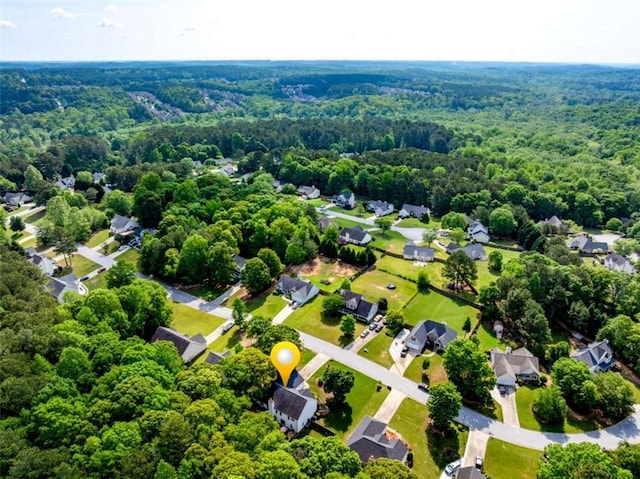 drone / aerial view with a residential view and a wooded view