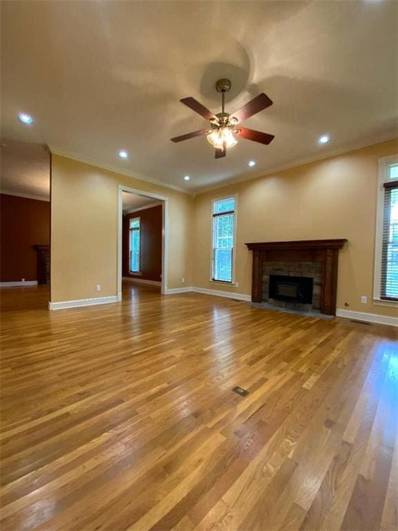 unfurnished living room featuring ceiling fan, light hardwood / wood-style floors, and crown molding