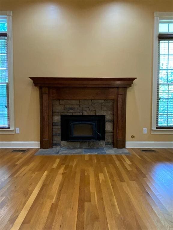 interior details featuring a fireplace and hardwood / wood-style flooring