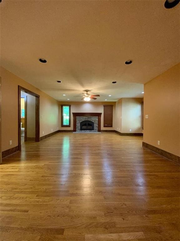 unfurnished living room with ceiling fan and hardwood / wood-style flooring