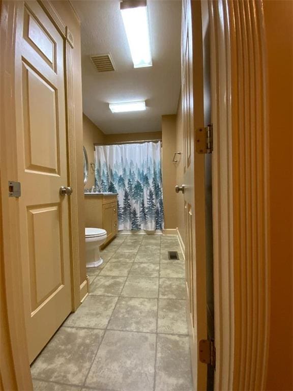 bathroom featuring tile patterned flooring and toilet