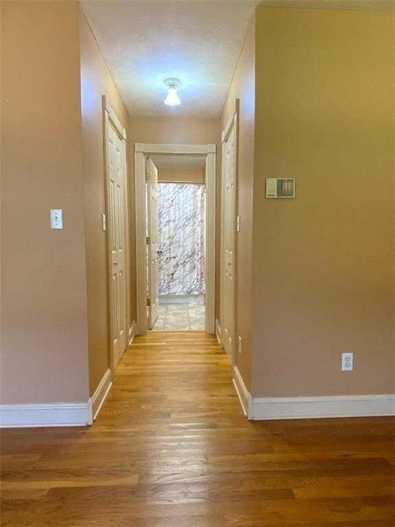 hall with light hardwood / wood-style floors