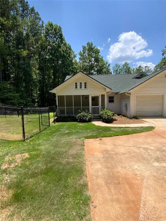 view of front of home with a front lawn and a garage