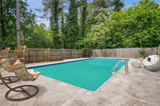 view of swimming pool featuring a fenced in pool, a fenced backyard, and a patio