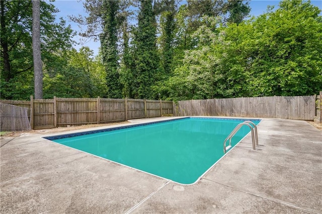view of swimming pool with a fenced backyard, a fenced in pool, and a patio