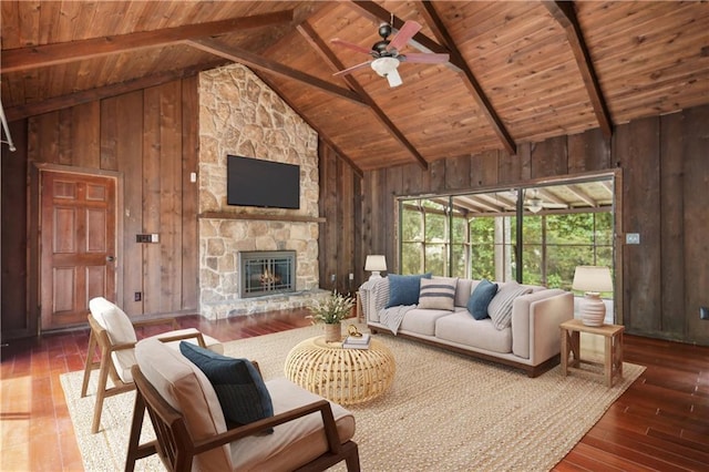 living room featuring a ceiling fan, beam ceiling, wooden ceiling, wooden walls, and hardwood / wood-style floors