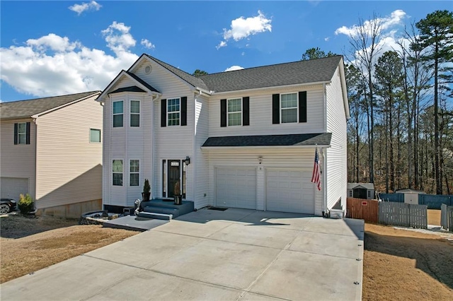 view of front of property featuring an attached garage, driveway, and a shingled roof