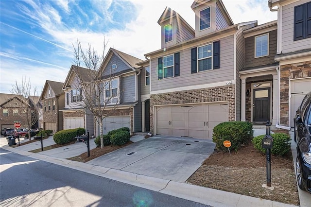 5008 Whiteoak Pointe SE Unit 15, Smyrna, GA 30080 - view of property featuring an attached garage, a residential view, driveway, and brick siding