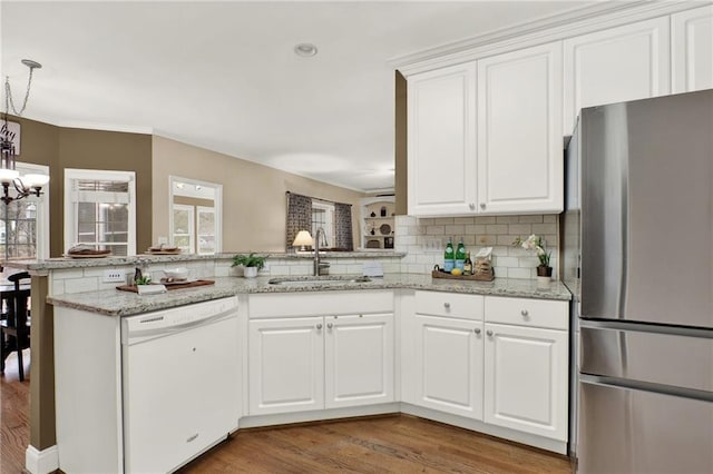 kitchen with white cabinetry, stainless steel fridge, dishwasher, and sink