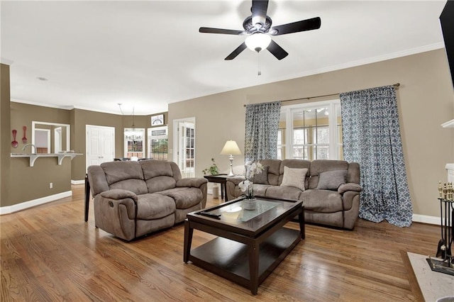 living room with ornamental molding, hardwood / wood-style floors, and ceiling fan