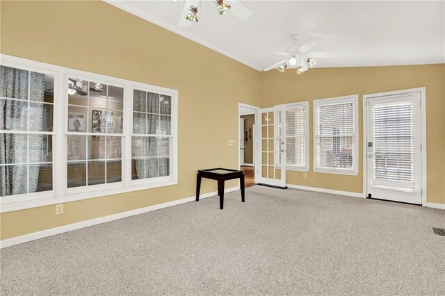 spare room with ceiling fan, ornamental molding, carpet flooring, and vaulted ceiling