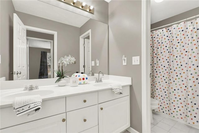 bathroom featuring a shower with curtain, vanity, toilet, and tile patterned flooring