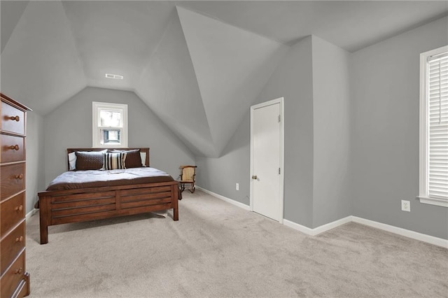 carpeted bedroom featuring lofted ceiling