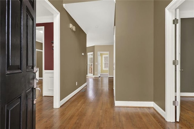 entrance foyer with crown molding and hardwood / wood-style floors