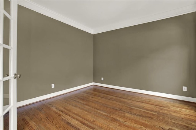 unfurnished room featuring ornamental molding and hardwood / wood-style floors