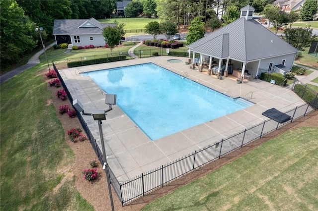 view of pool with a yard, a patio area, and an in ground hot tub