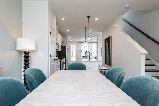 dining space with recessed lighting and stairs