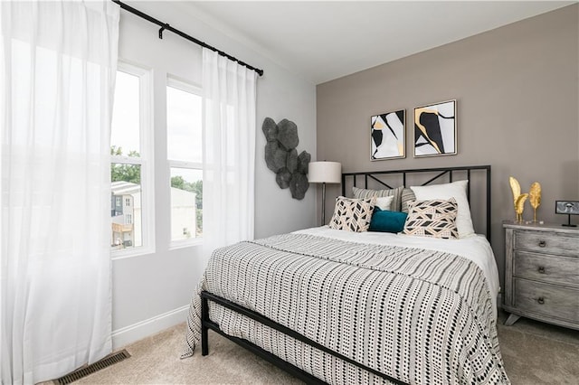 bedroom featuring carpet flooring, visible vents, and baseboards