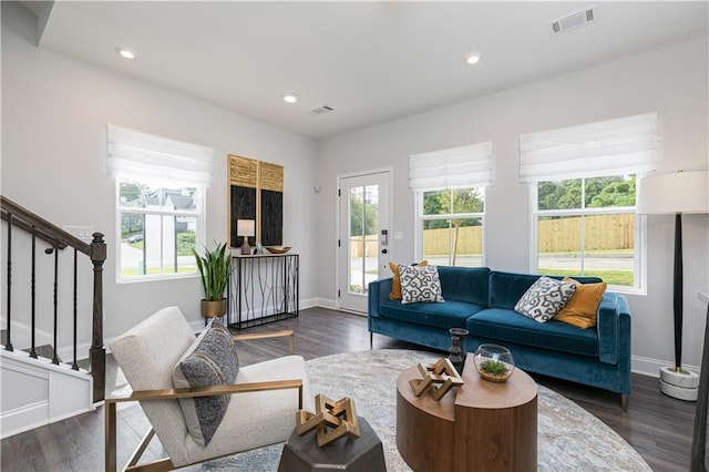 living room with dark wood-type flooring, stairway, recessed lighting, and visible vents