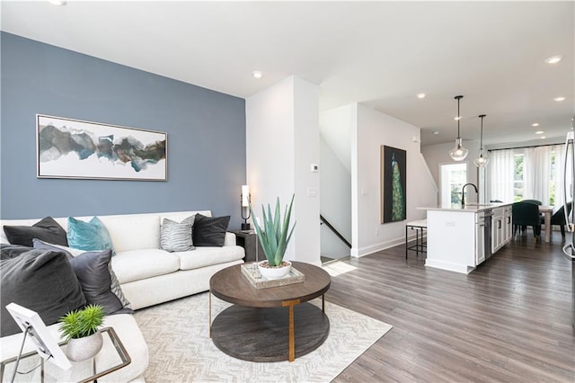 living room with recessed lighting, baseboards, and dark wood-type flooring