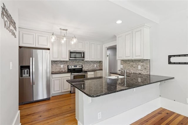 1382 6th Ave, Auburn, GA 30011 - kitchen featuring stainless steel appliances, backsplash, a peninsula, white cabinetry, and recessed lighting