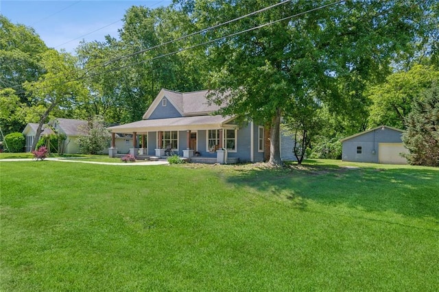 1382 6th Ave, Auburn, GA 30011 - view of front facade featuring covered porch, a garage, a front yard, and an outbuilding