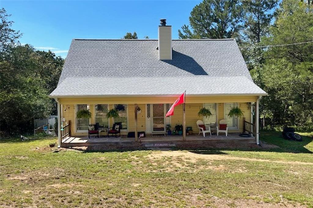 rear view of house with a yard