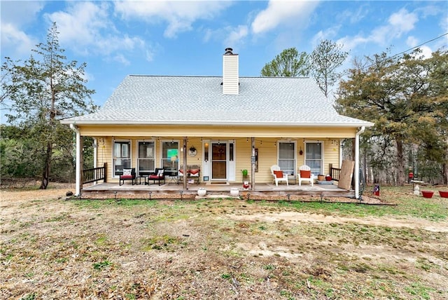 rear view of house featuring a porch