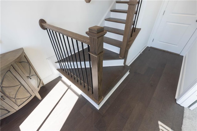 staircase with hardwood / wood-style floors