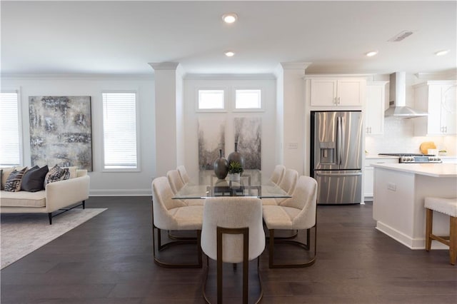 dining room with ornamental molding and dark wood-type flooring