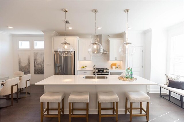 kitchen with stainless steel microwave, dark wood-type flooring, wall chimney exhaust hood, decorative backsplash, and white cabinetry