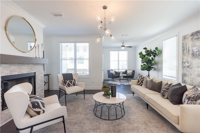 living room featuring hardwood / wood-style floors, ceiling fan, a fireplace, and crown molding