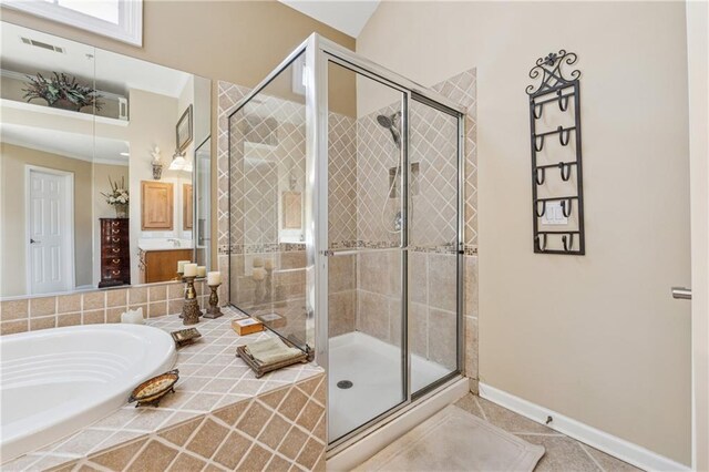 11715 Dancliff Trce, Alpharetta, GA 30009 - bathroom with a stall shower, a garden tub, baseboards, and tile patterned floors