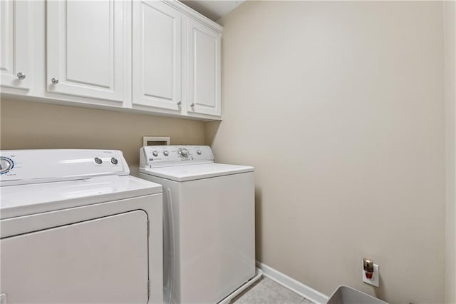 11715 Dancliff Trce, Alpharetta, GA 30009 - laundry room featuring cabinet space, washer and dryer, baseboards, and tile patterned floors