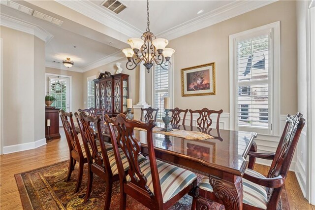 11715 Dancliff Trce, Alpharetta, GA 30009 - dining area with a chandelier, healthy amount of natural light, wood finished floors, and ornamental molding