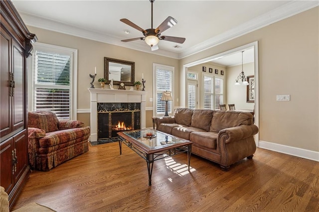 11715 Dancliff Trce, Alpharetta, GA 30009 - living room featuring healthy amount of natural light, a fireplace, a ceiling fan, wood finished floors, and ornamental molding