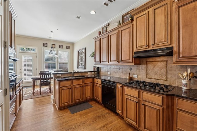 11715 Dancliff Trce, Alpharetta, GA 30009 - kitchen with black appliances, under cabinet range hood, a sink, brown cabinetry, and crown molding