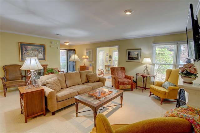 living room featuring crown molding, plenty of natural light, visible vents, and light carpet