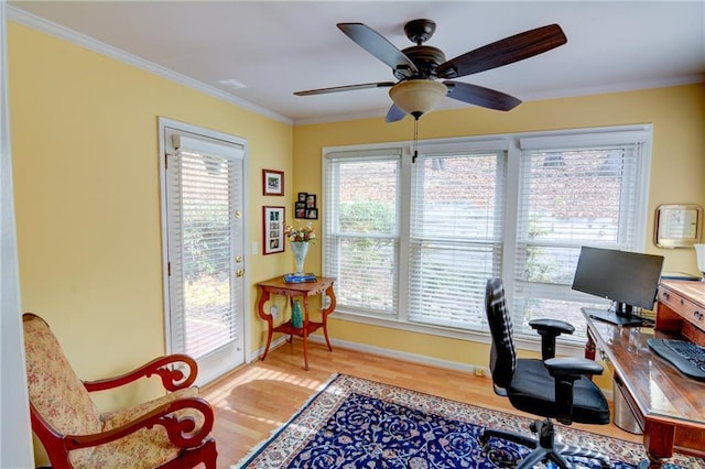 office area featuring baseboards, crown molding, ceiling fan, and wood finished floors