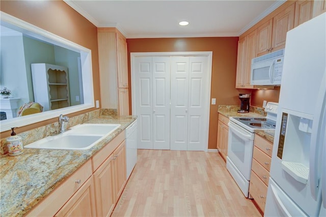 kitchen featuring a sink, light wood-type flooring, white appliances, and ornamental molding