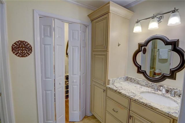 bathroom featuring ornamental molding and vanity