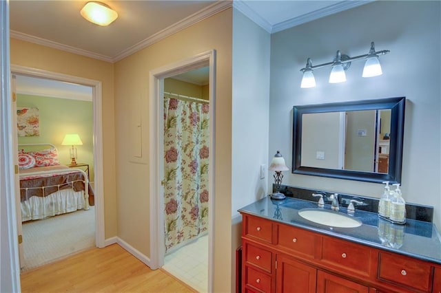 bathroom with vanity, ensuite bath, crown molding, and wood finished floors