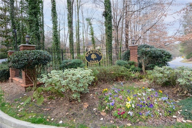 community sign featuring fence